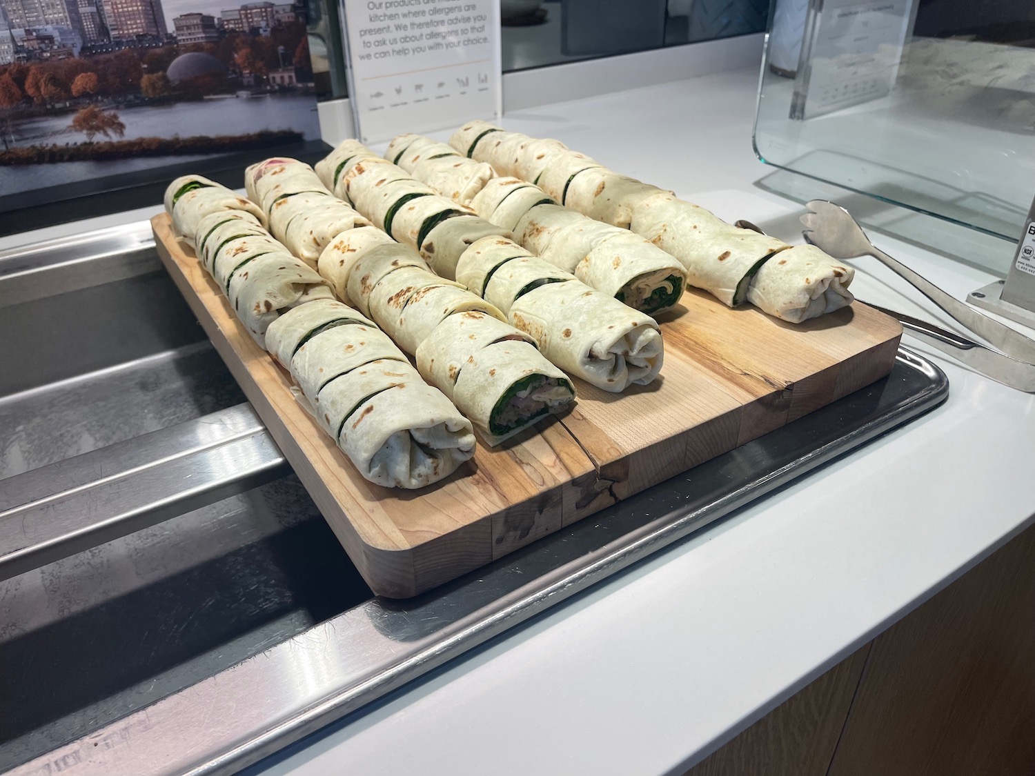 a group of burritos on a wood board