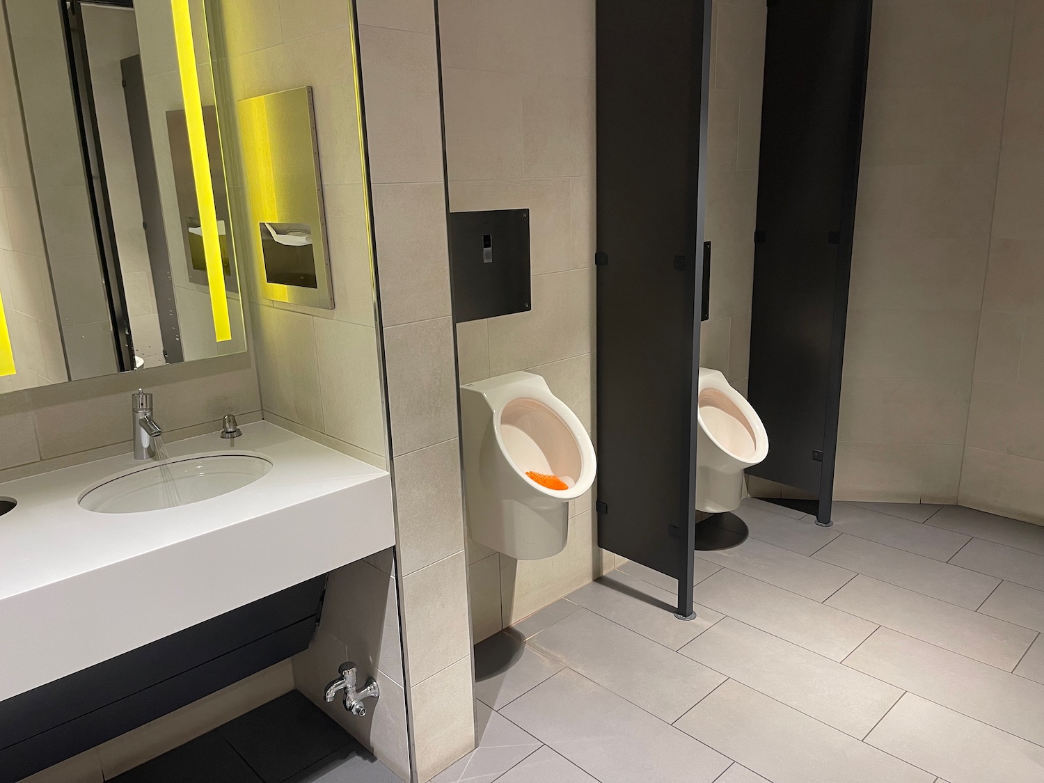 a bathroom with urinals and sink