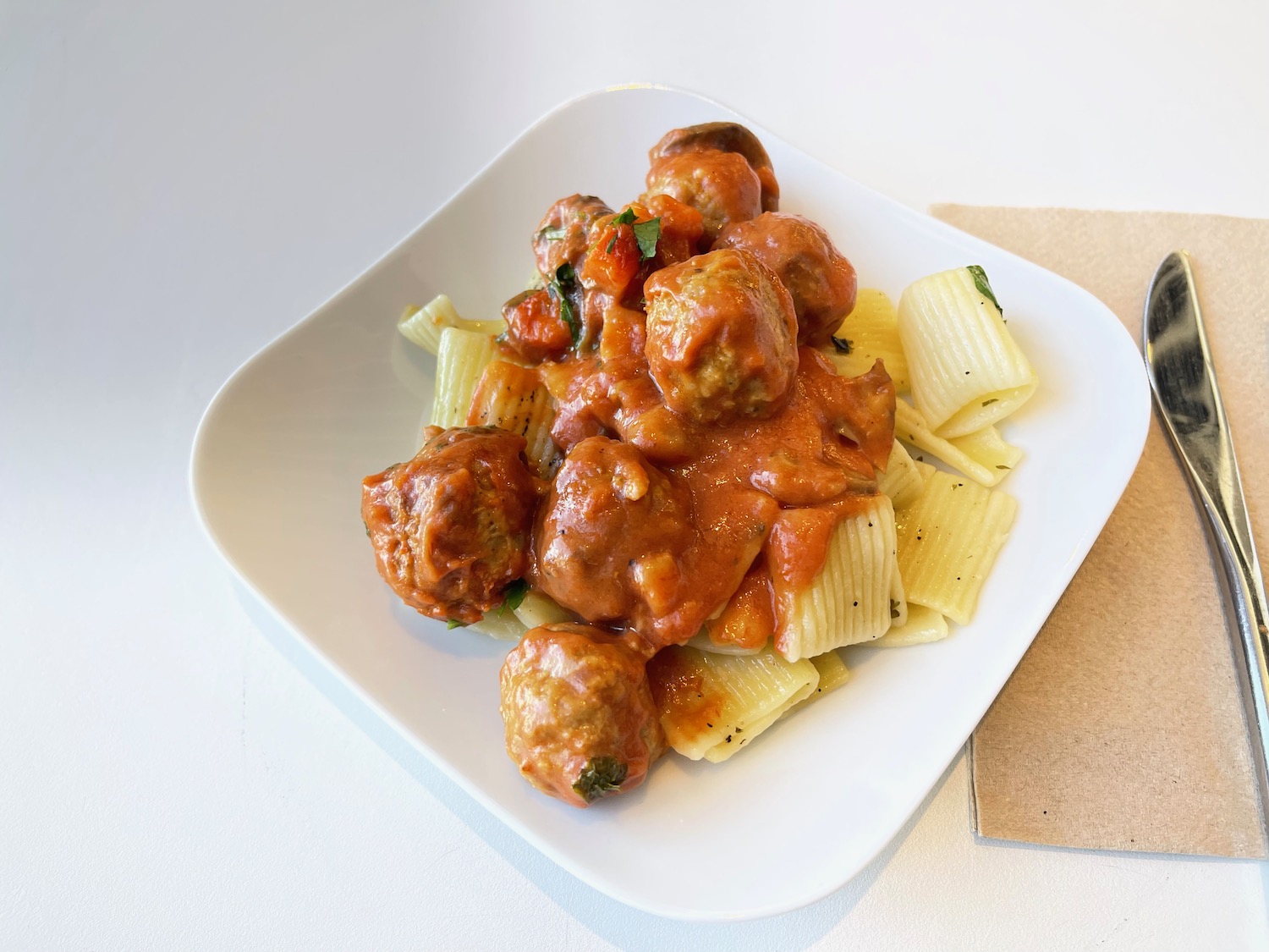 a plate of pasta with meatballs and sauce