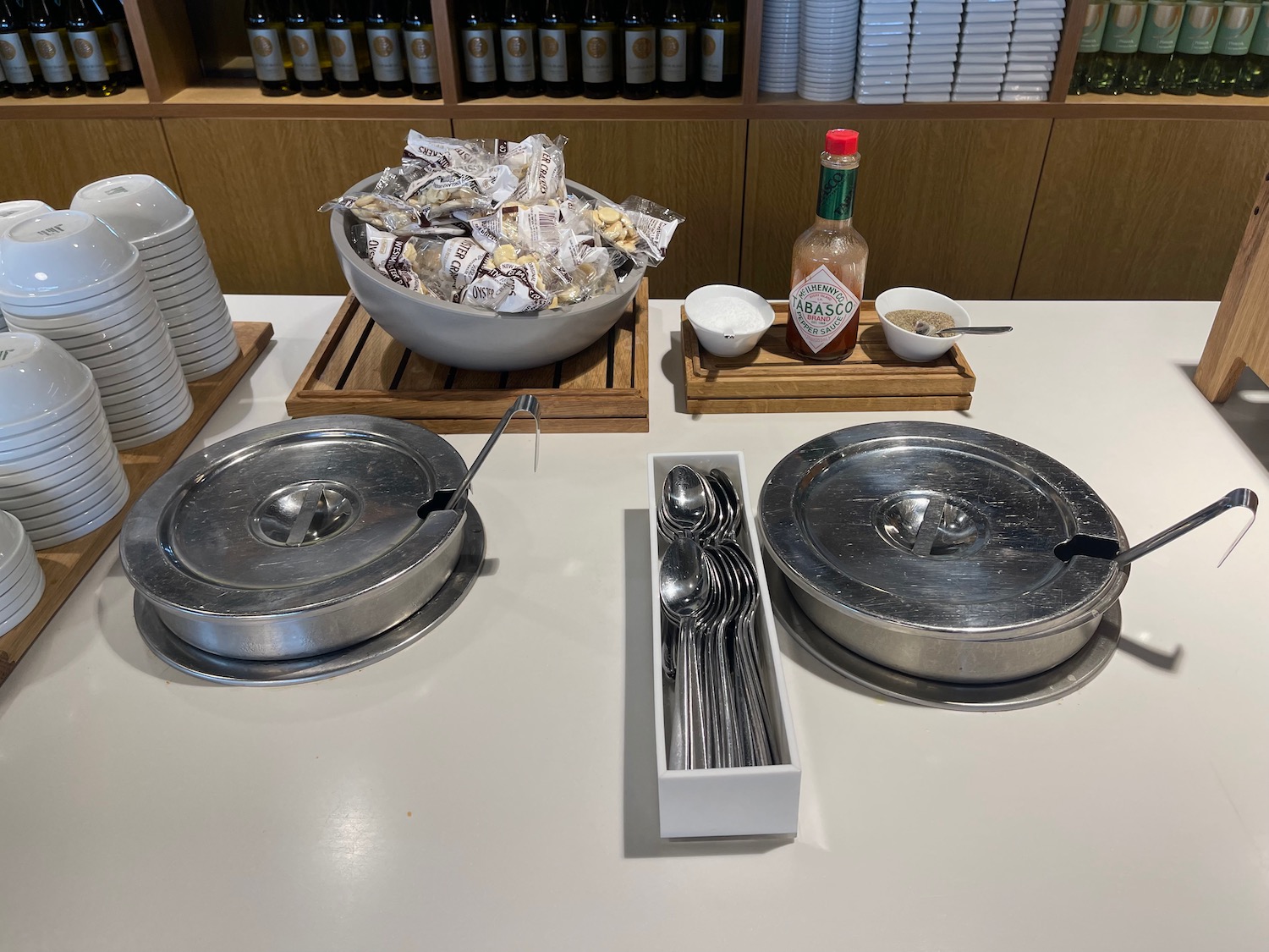 a table with silver bowls and spoons