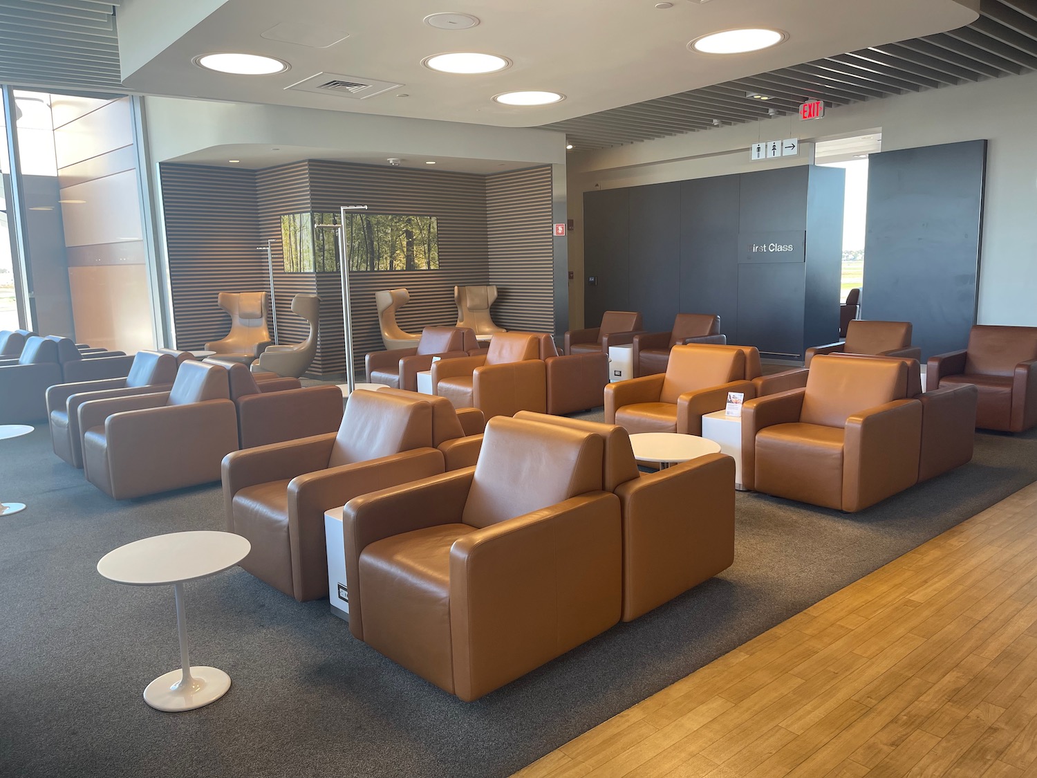 a room with brown leather chairs and a table