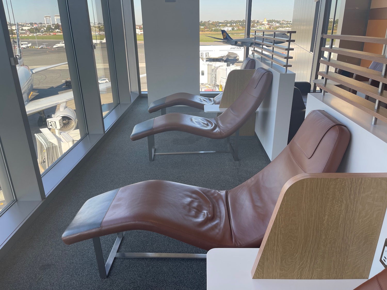 chairs in a room with windows and a plane