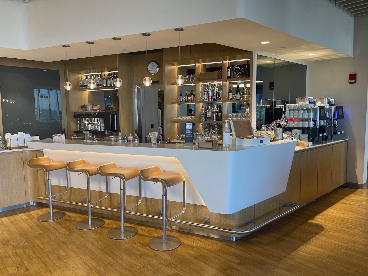 a bar with stools and bottles