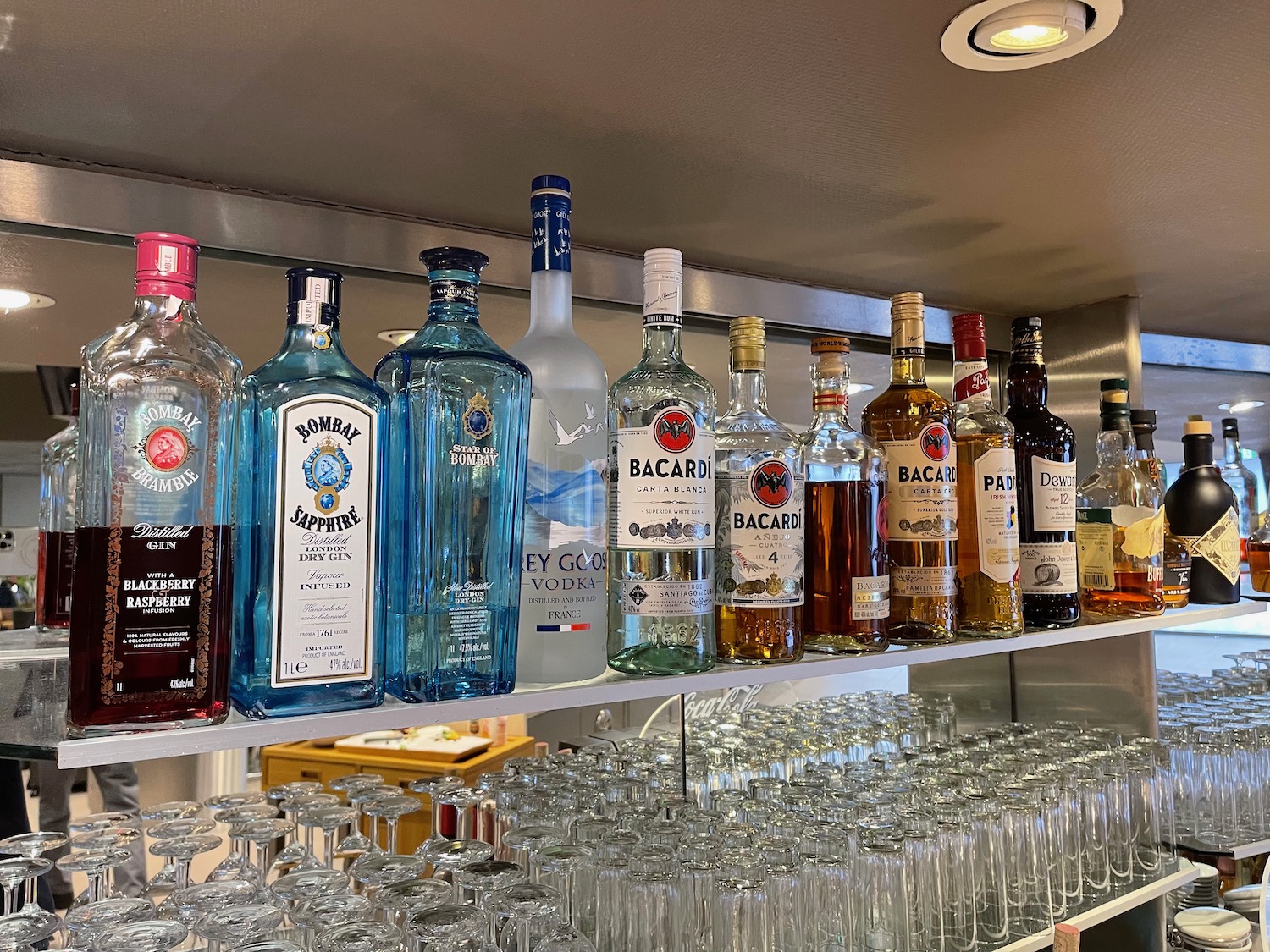 a shelf with bottles and glasses