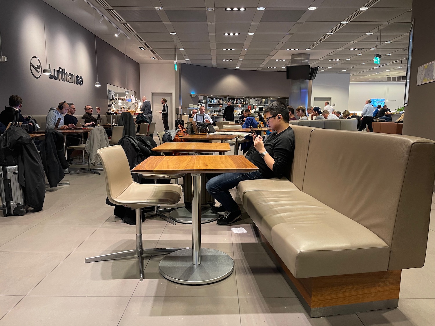 a group of people sitting at tables in a restaurant