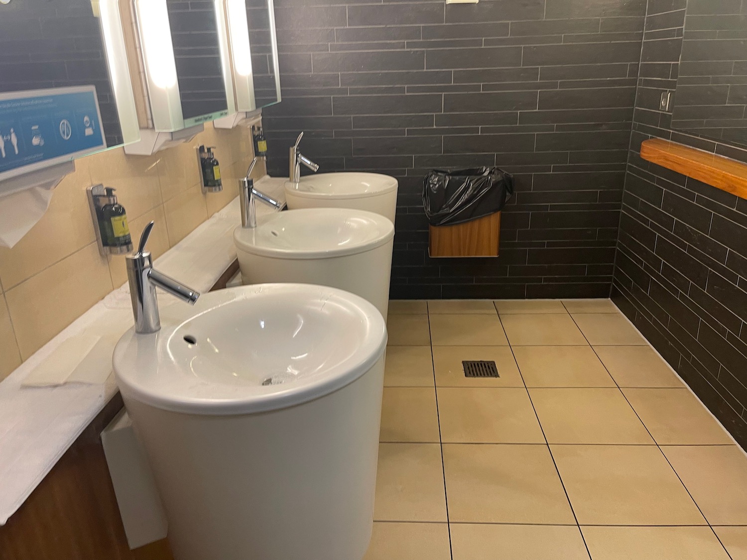 a bathroom with sinks and mirrors