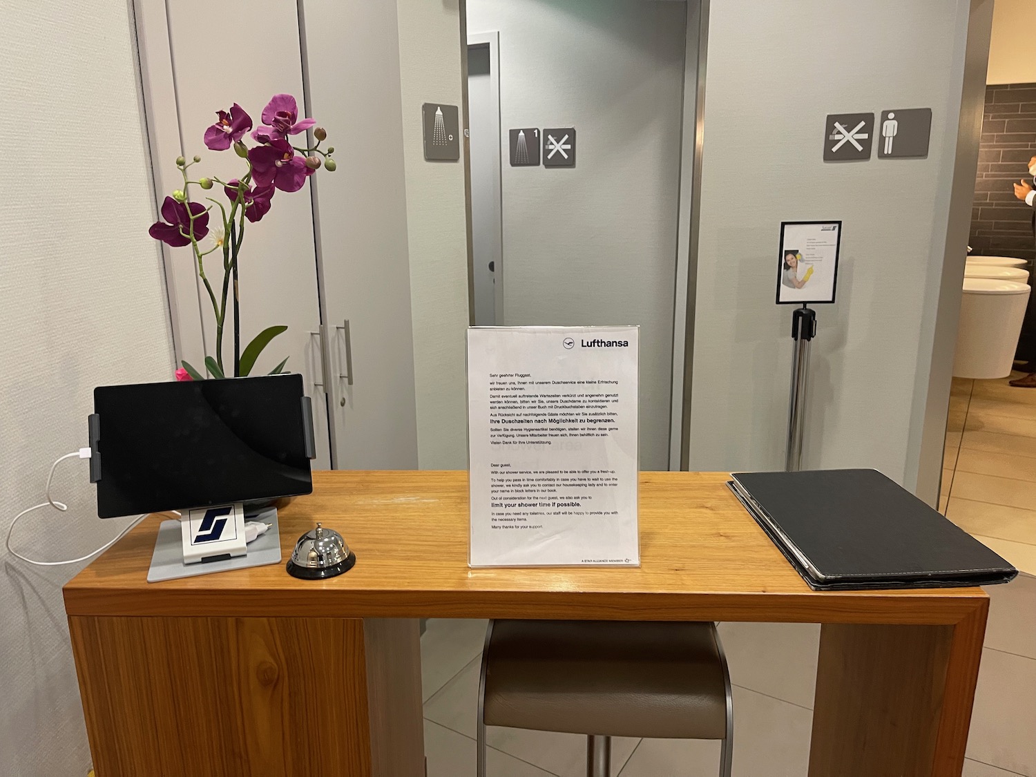 a desk with a sign and a flower in front of it