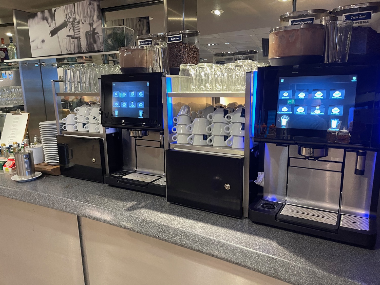 a coffee machine and cups on a counter