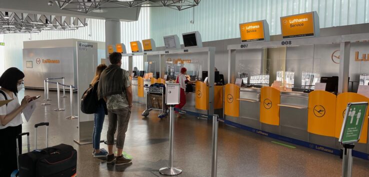 people standing in a line at an airport