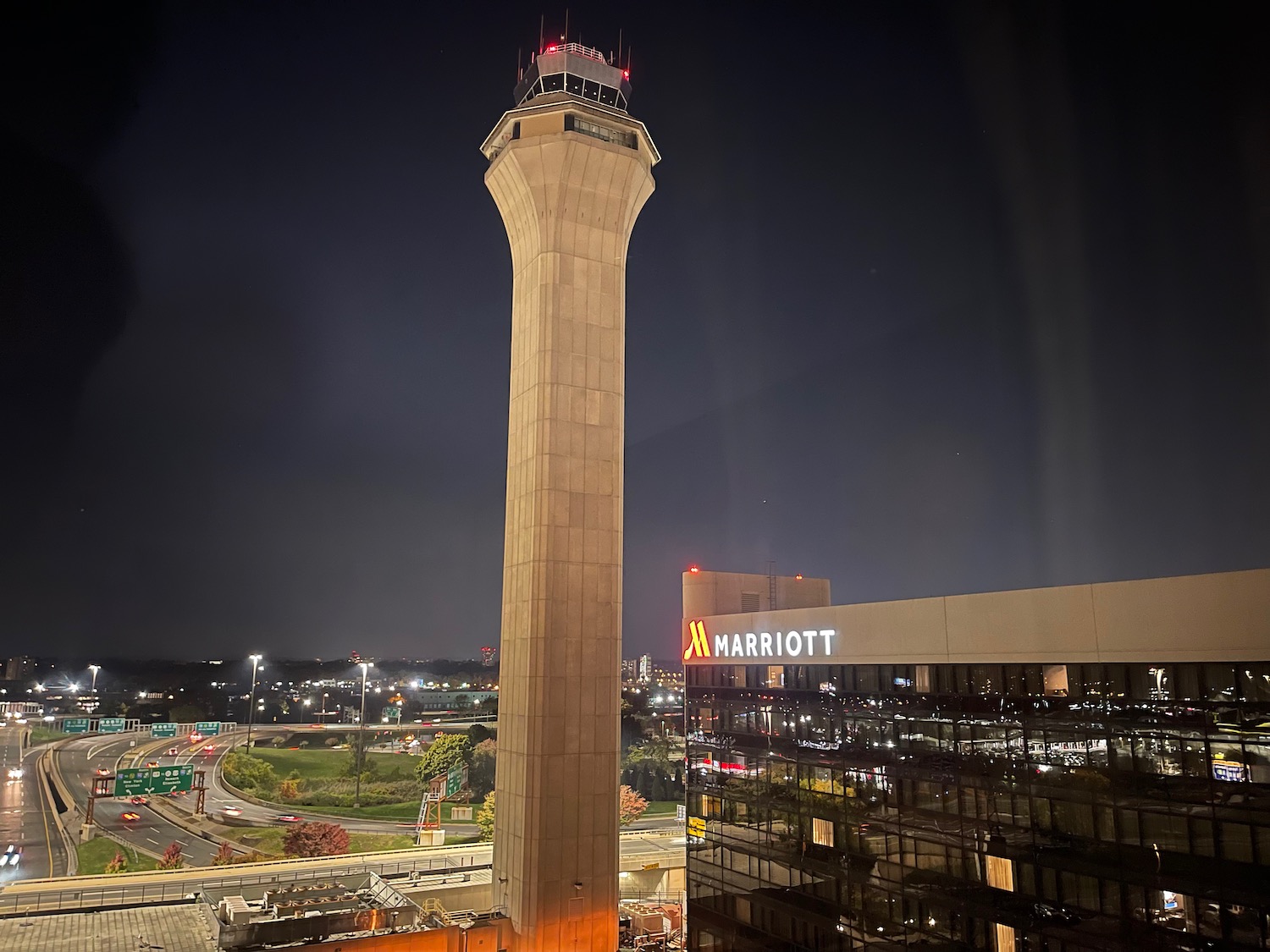 a tall tower with lights at night with Stratosphere Las Vegas in the background