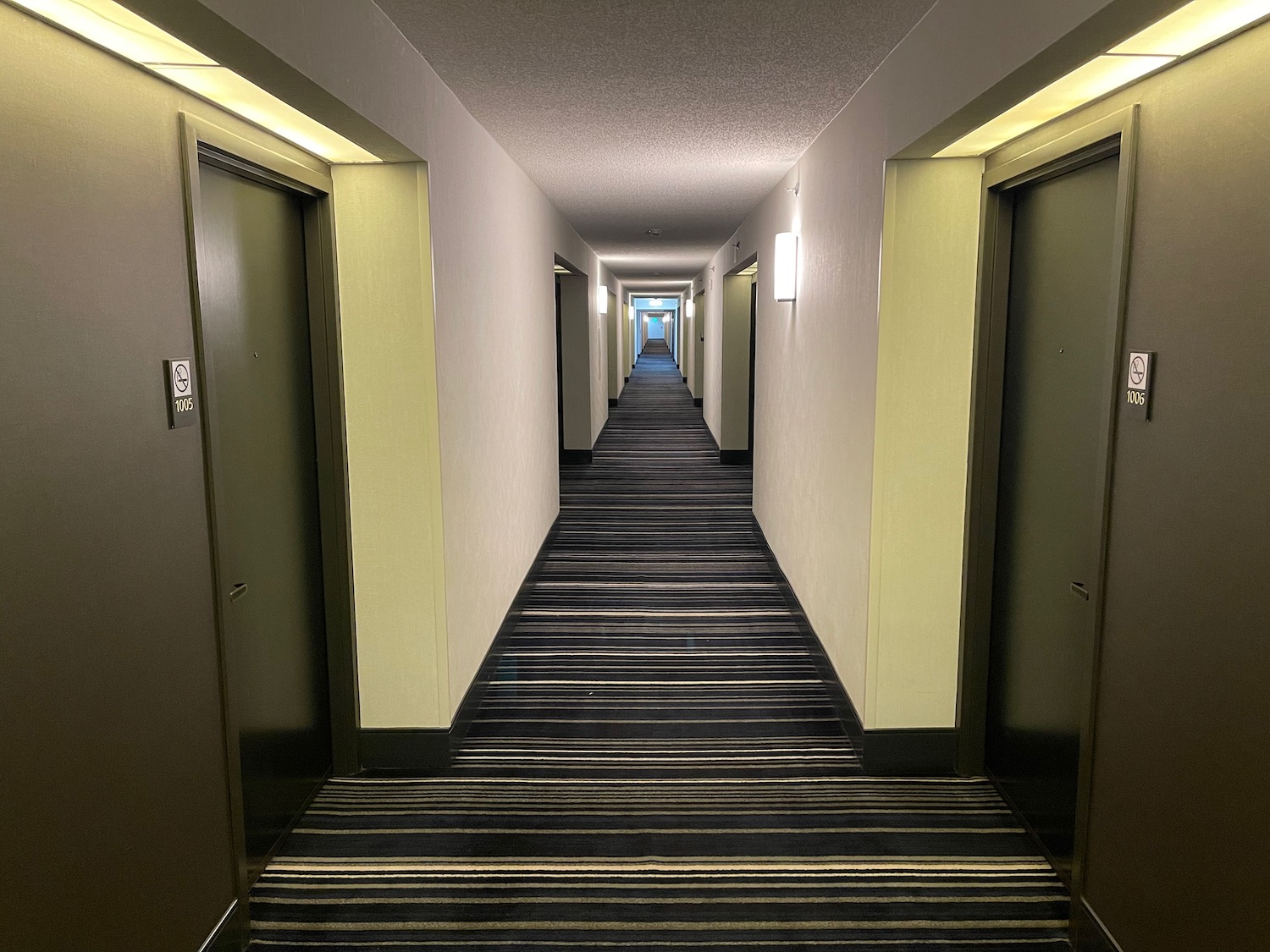 a hallway with doors and a light on the ceiling