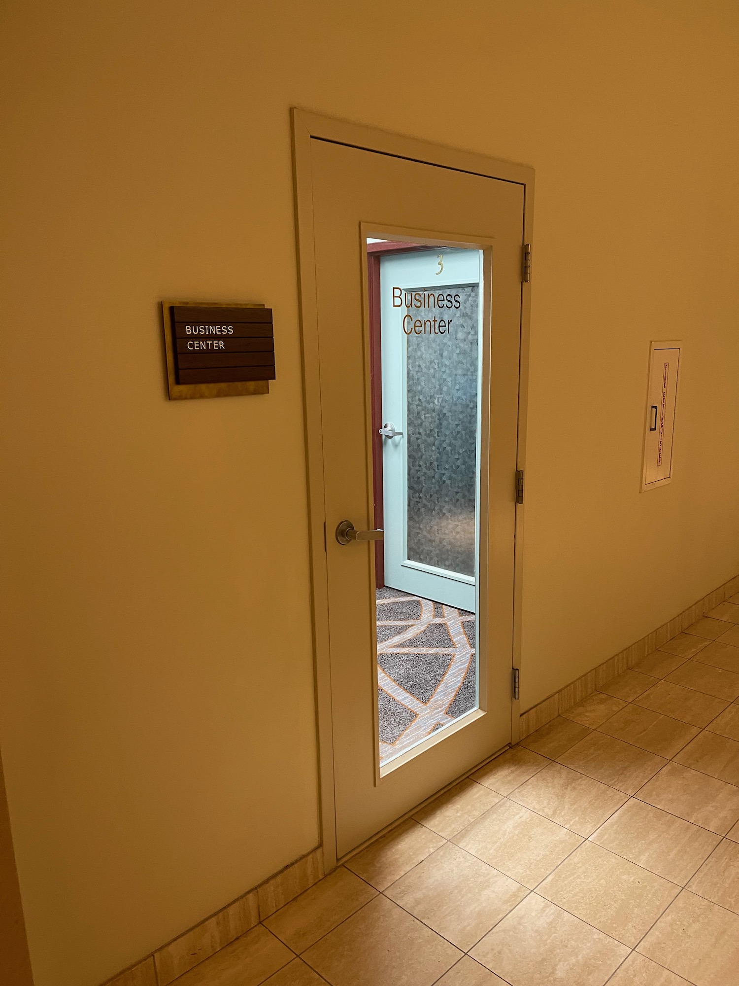 a door with a glass door and a sign on the wall