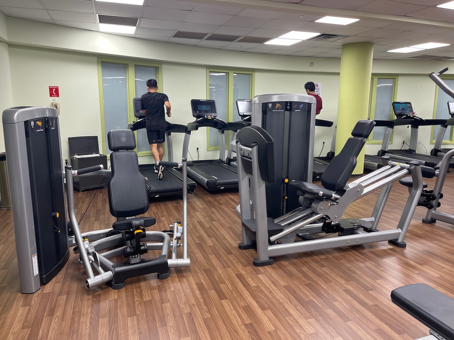 a man walking on treadmills in a gym