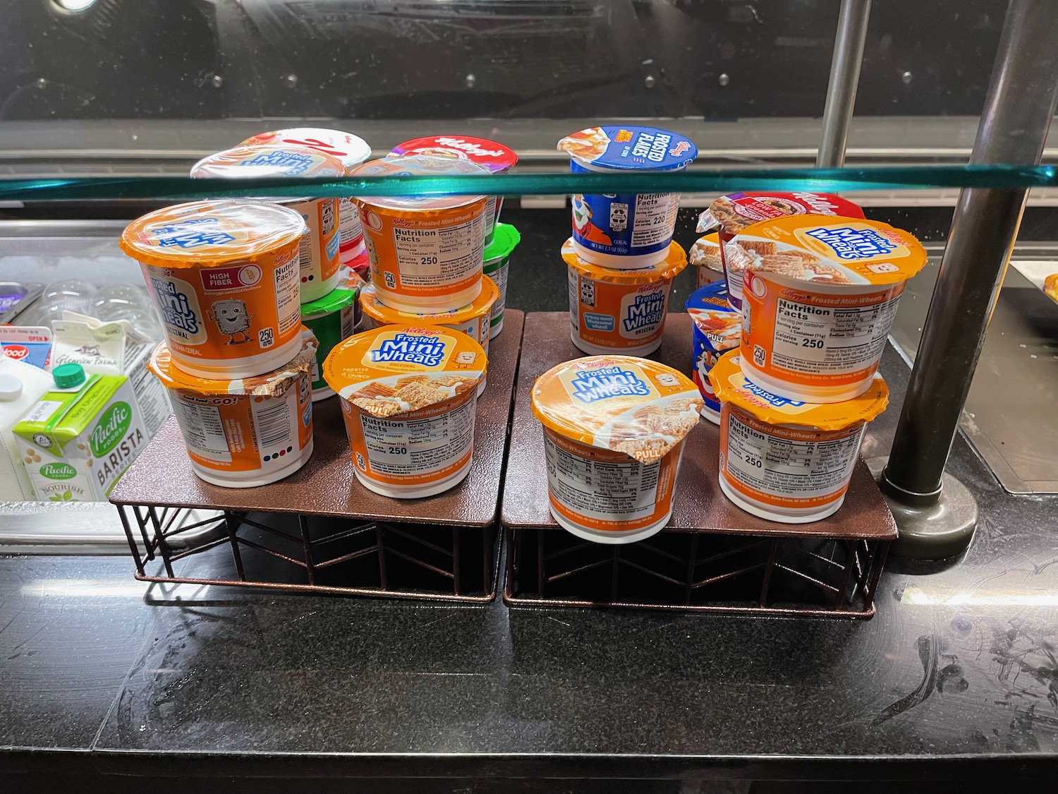 a group of yogurt containers on a shelf