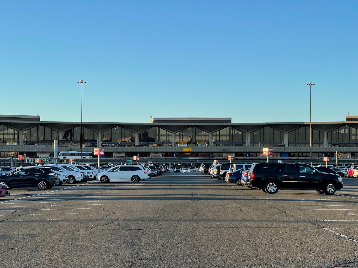 a parking lot with cars parked in front of a building