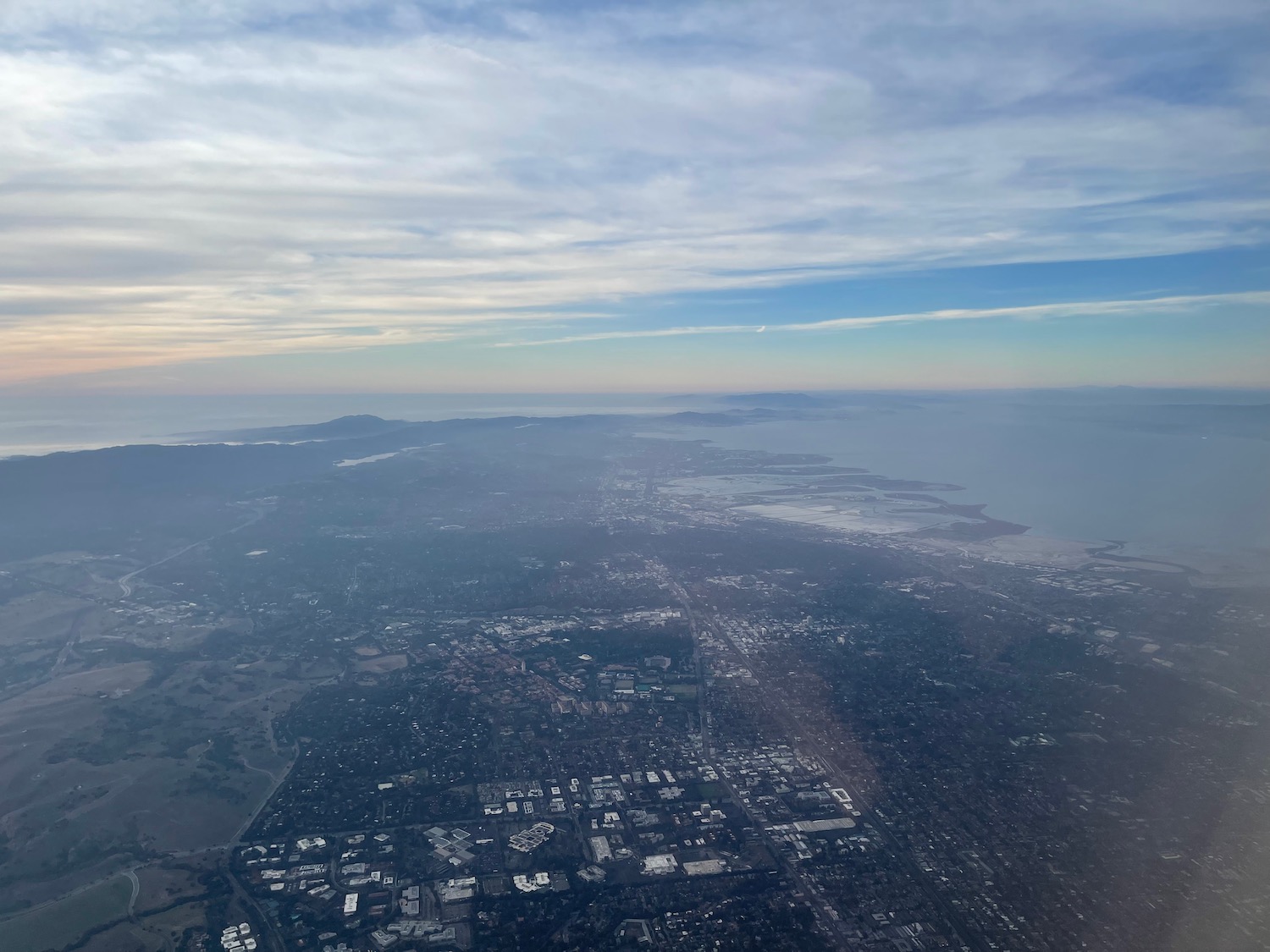 an aerial view of a city and the ocean