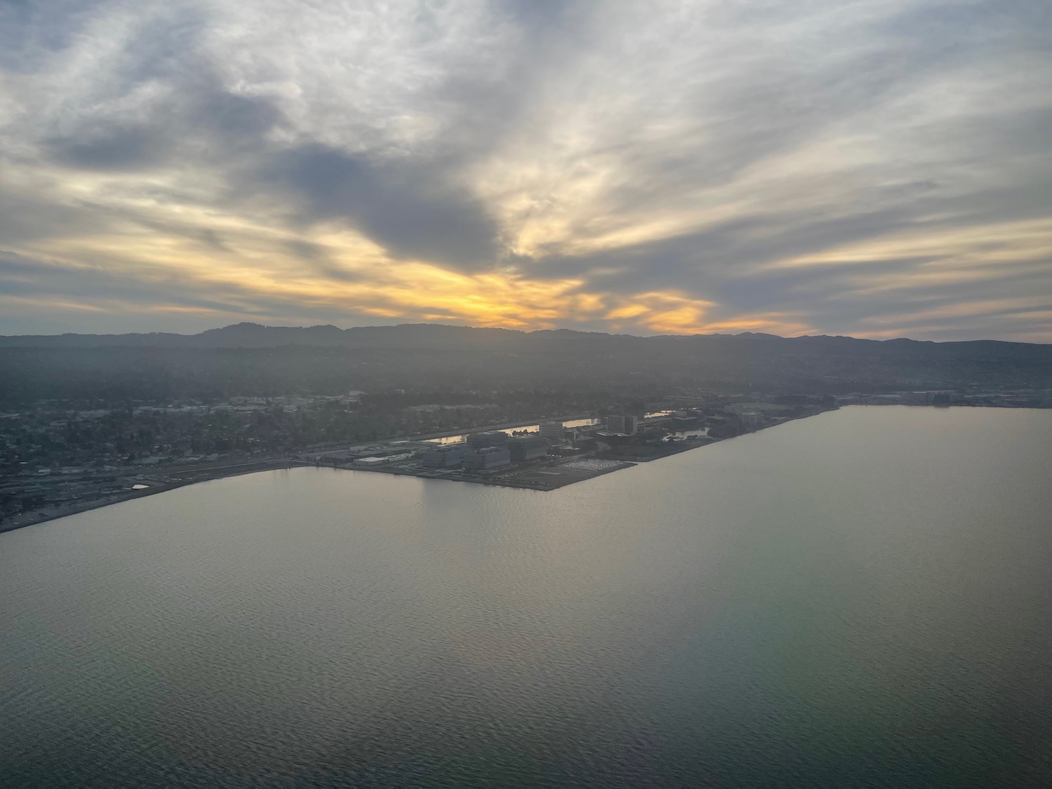 a body of water with buildings and a city in the distance