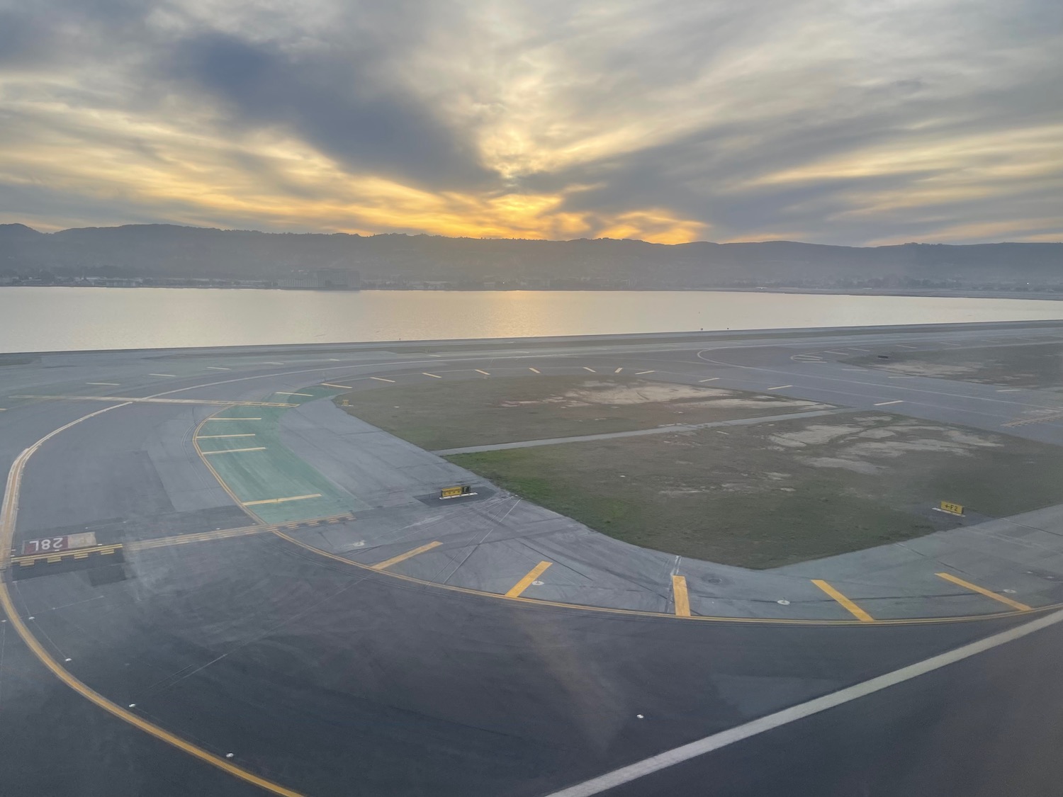 a runway with a body of water in the background