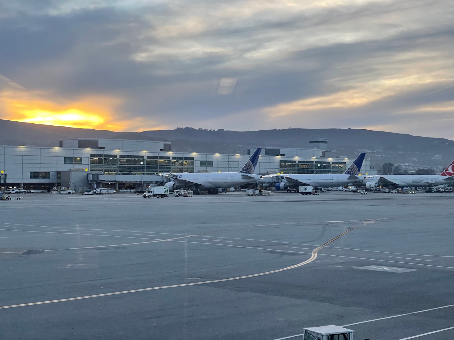 a large airport with airplanes parked in front of it