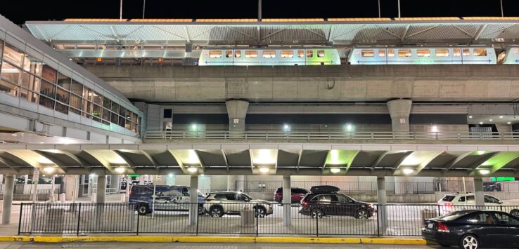 a parking lot with a train station