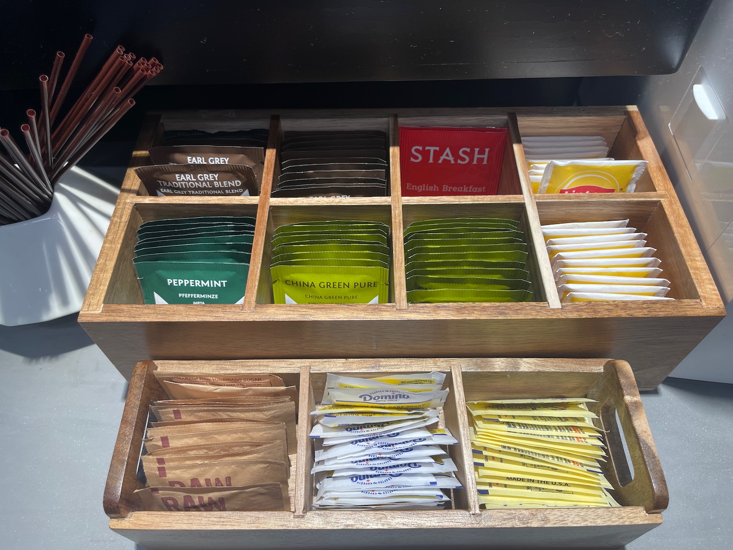 a wooden box with different types of condiments