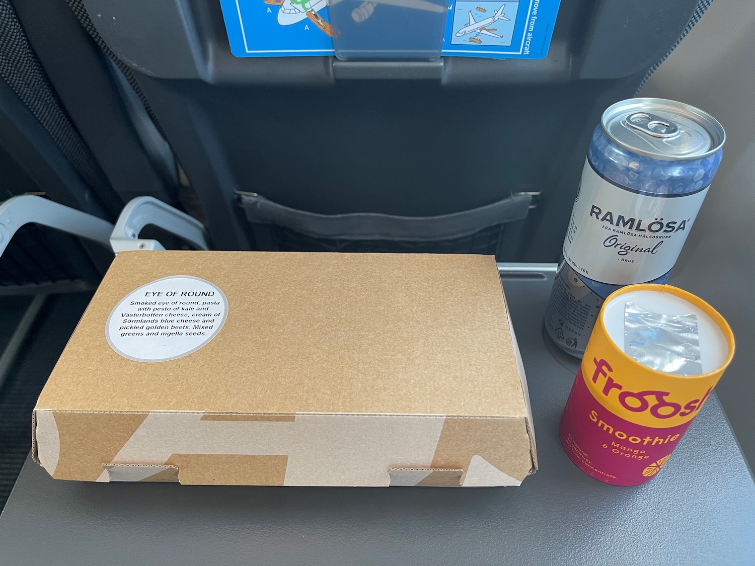 a pizza box and soda cans on a table