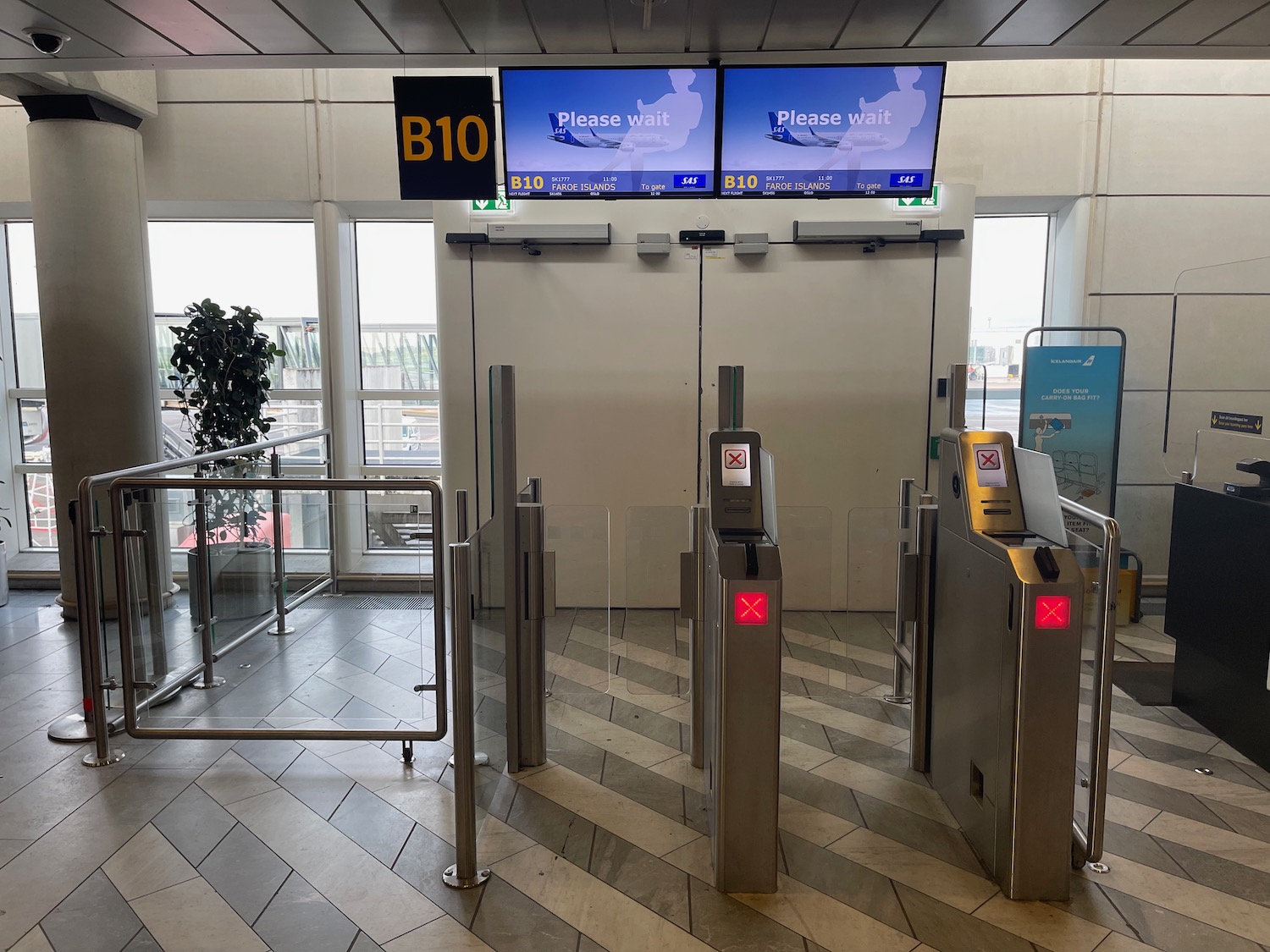 a gate with electronic signs and a screen