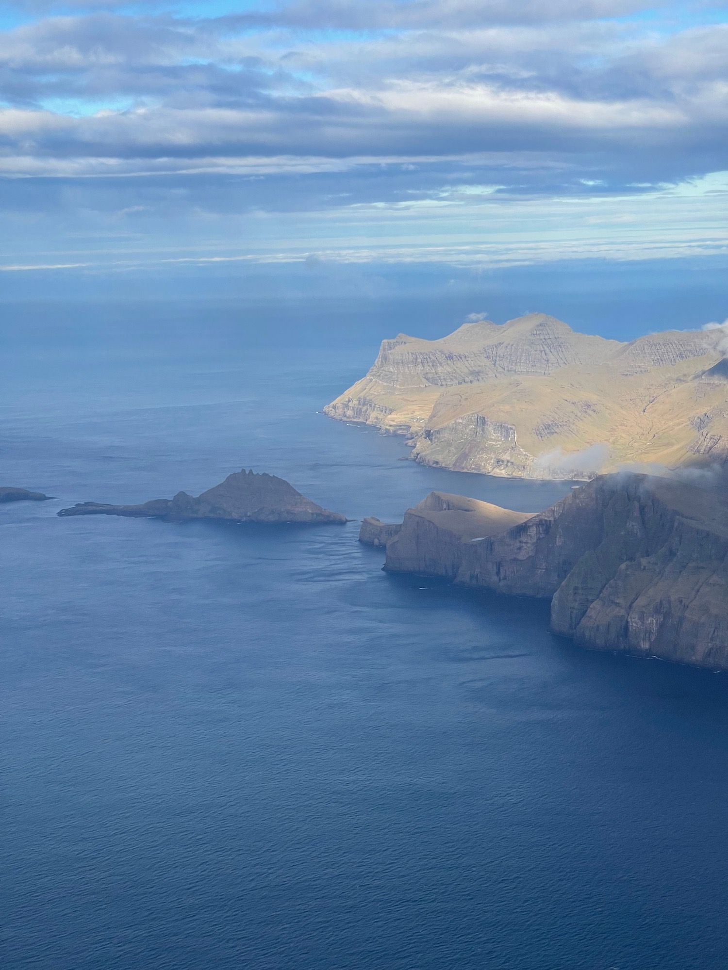 a large body of water with mountains in the distance