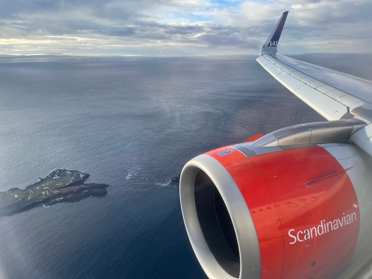 an airplane wing and a body of water