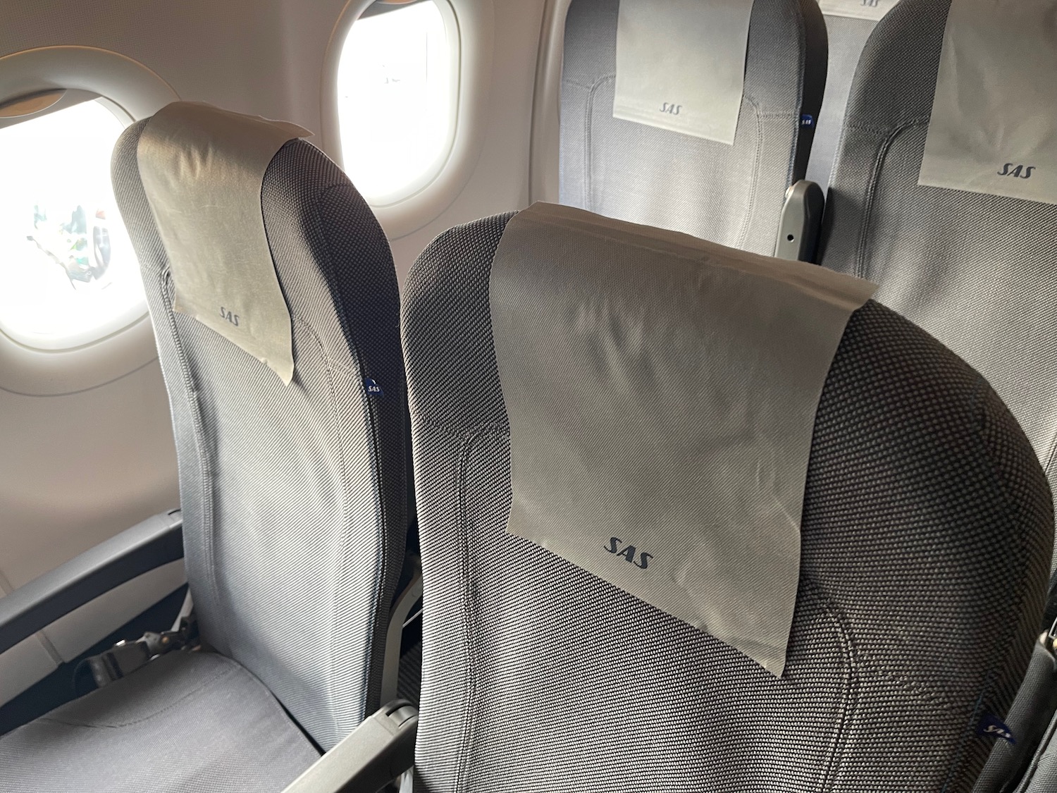 a row of seats with a white napkin on them