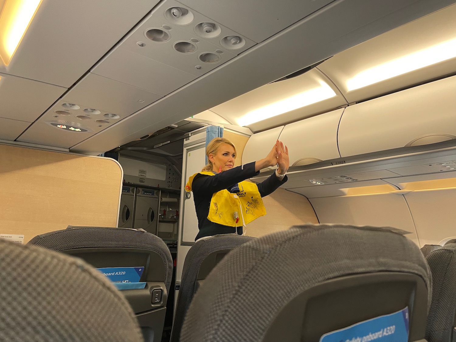 a woman in a yellow shirt waving