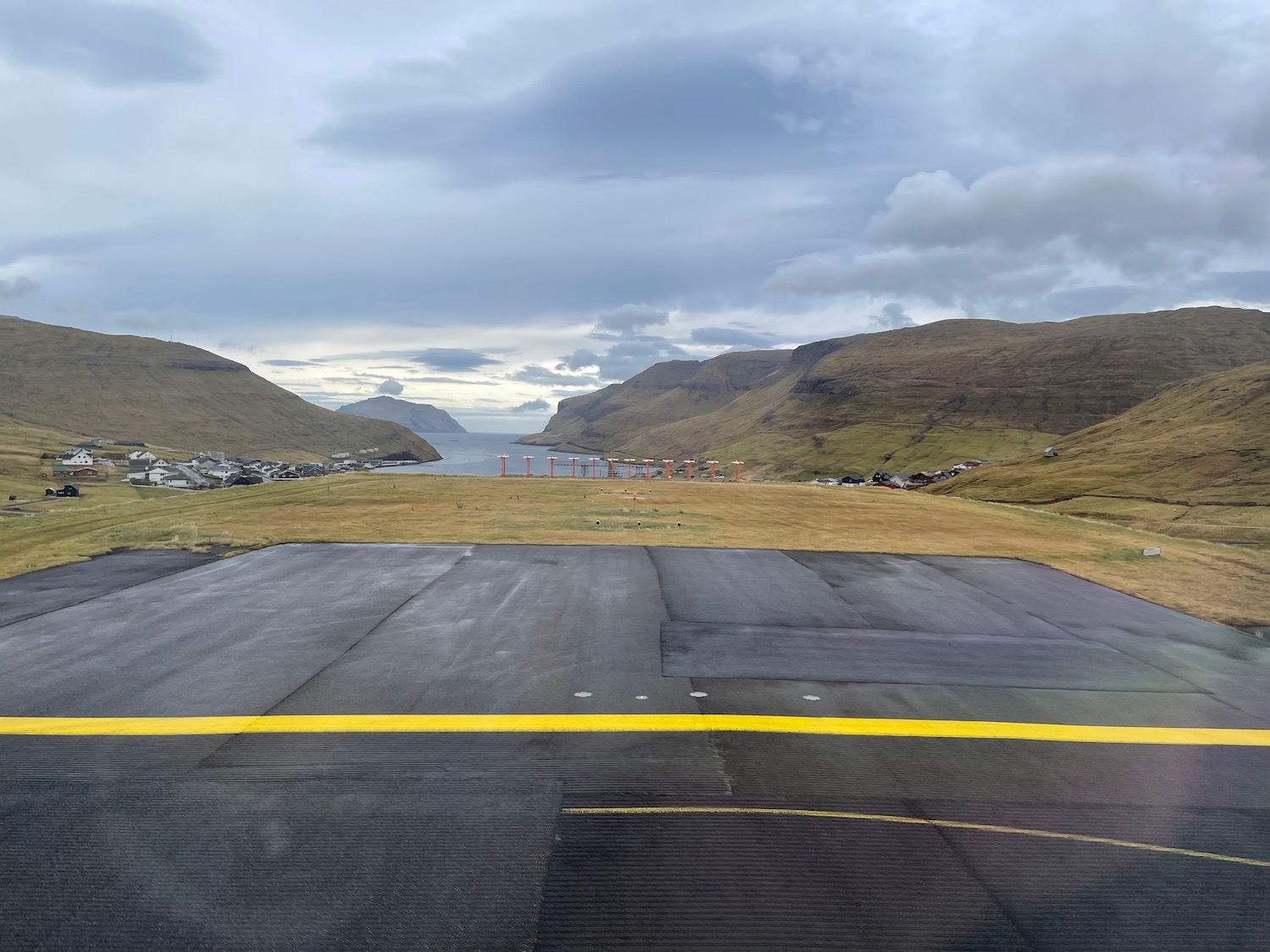 a road with a body of water in the background