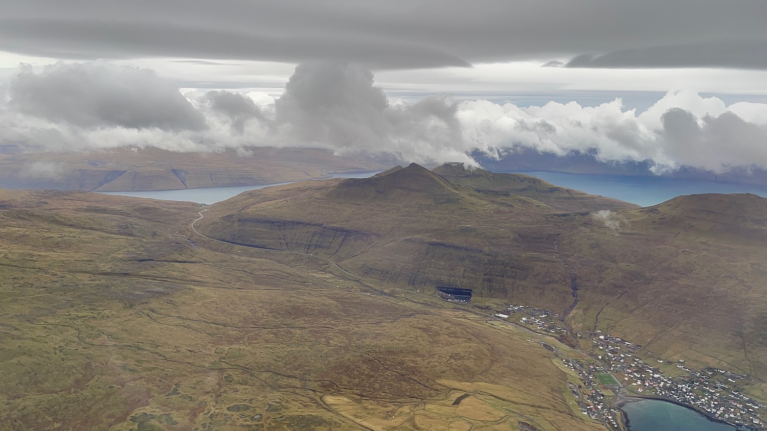 a landscape with a body of water and a mountain