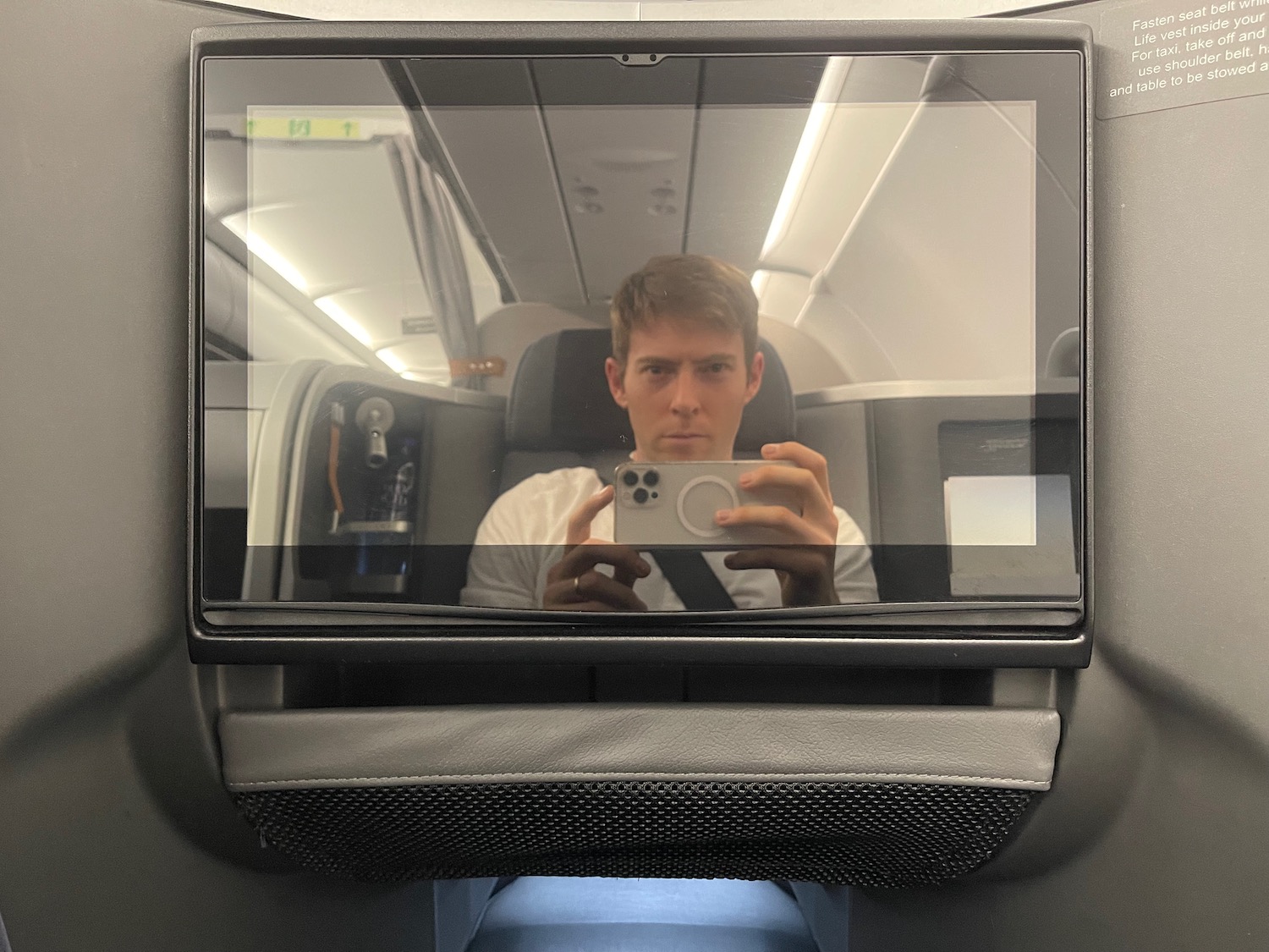 a man taking a selfie in an airplane