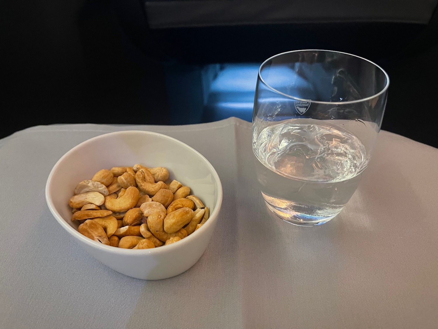 a bowl of nuts and a glass of water