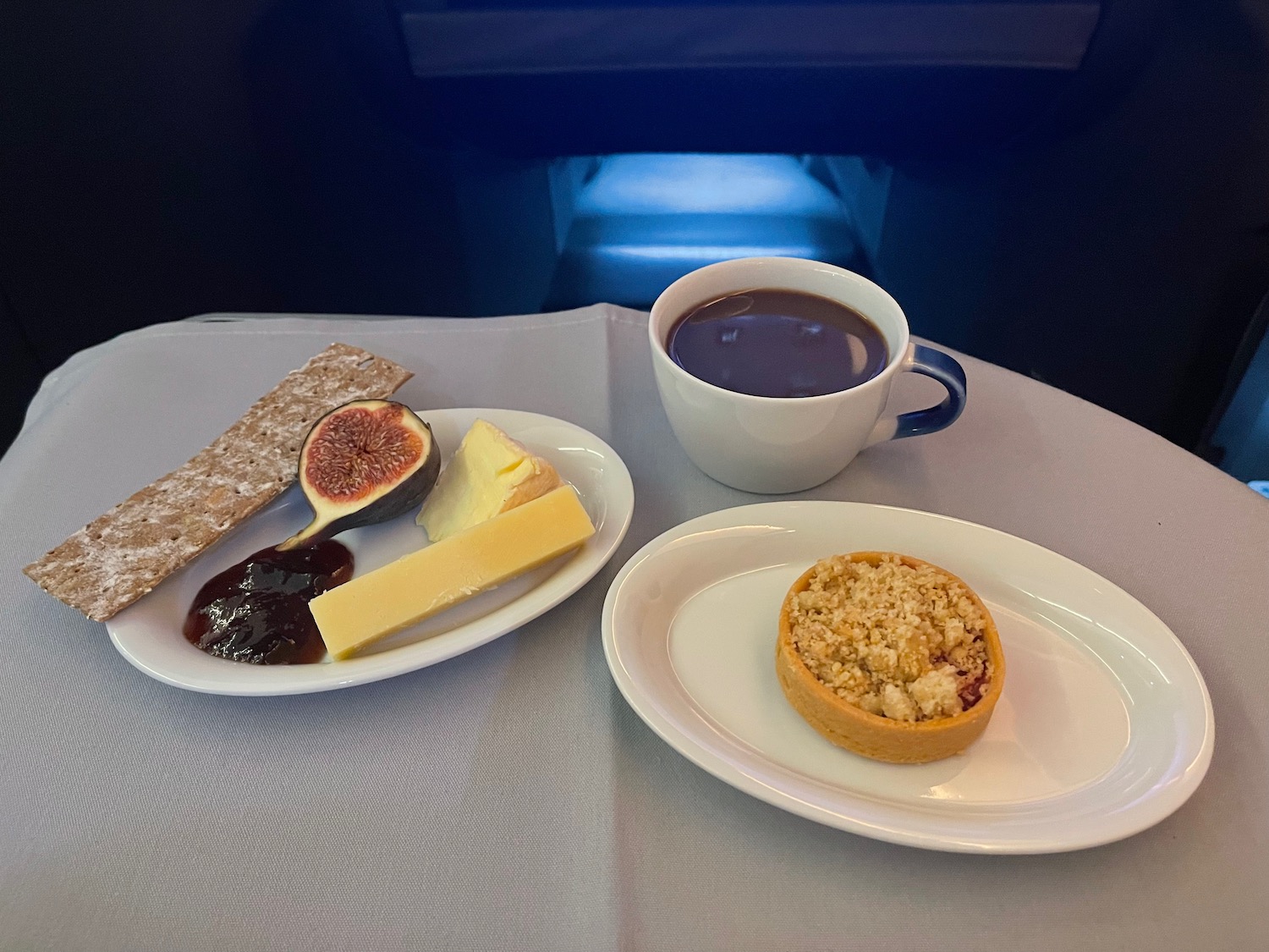 a plate of food and a cup of coffee on a table