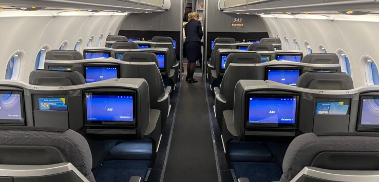 a woman standing in an airplane