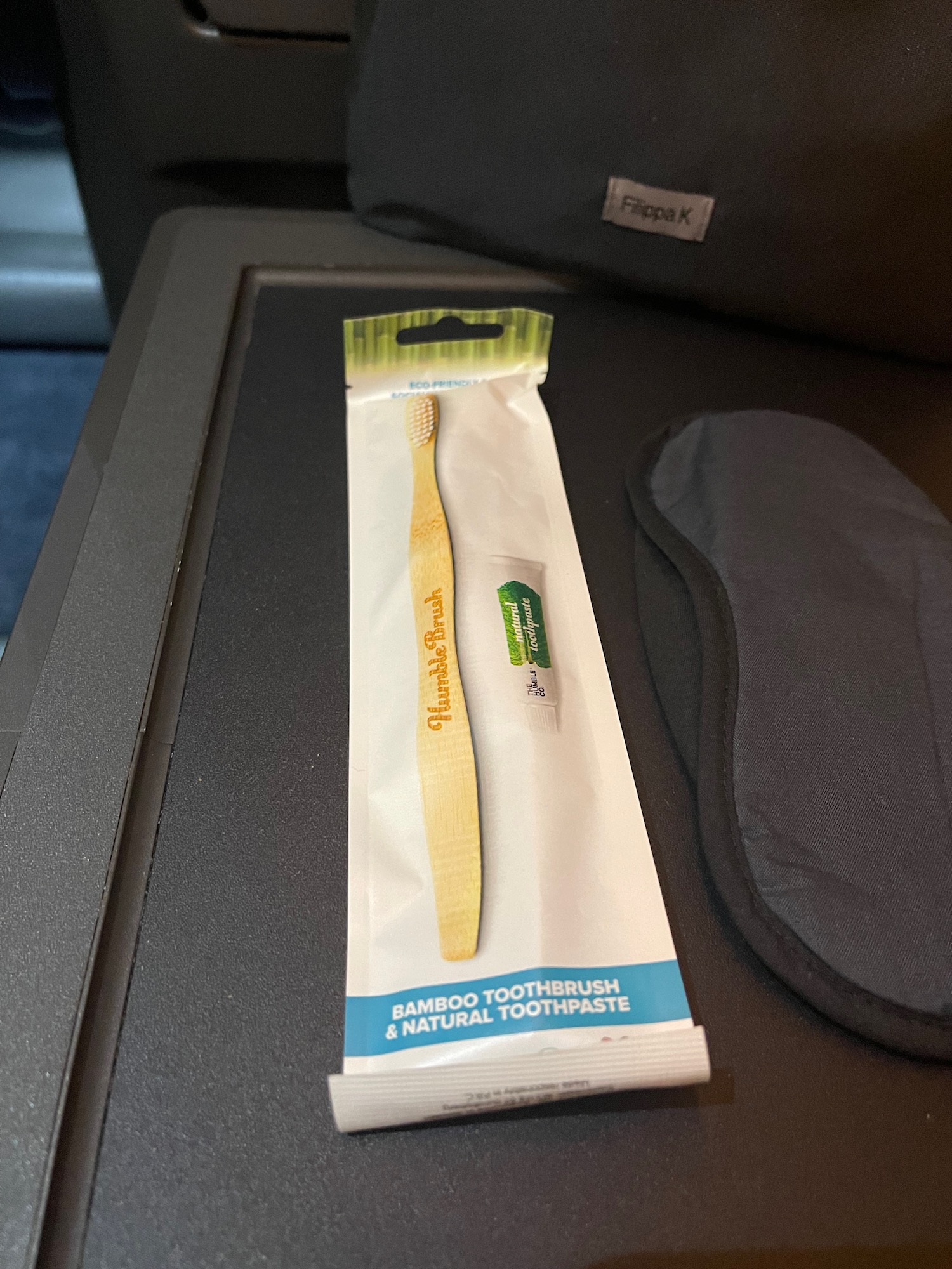 a toothbrush in a package on a black surface