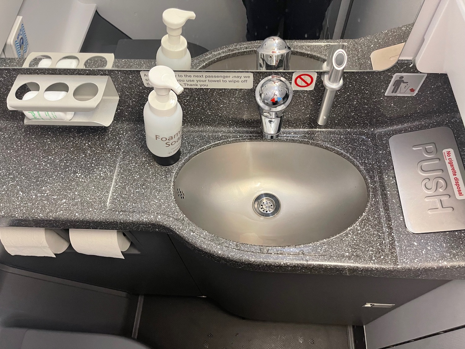 a sink with soap and soap dispenser