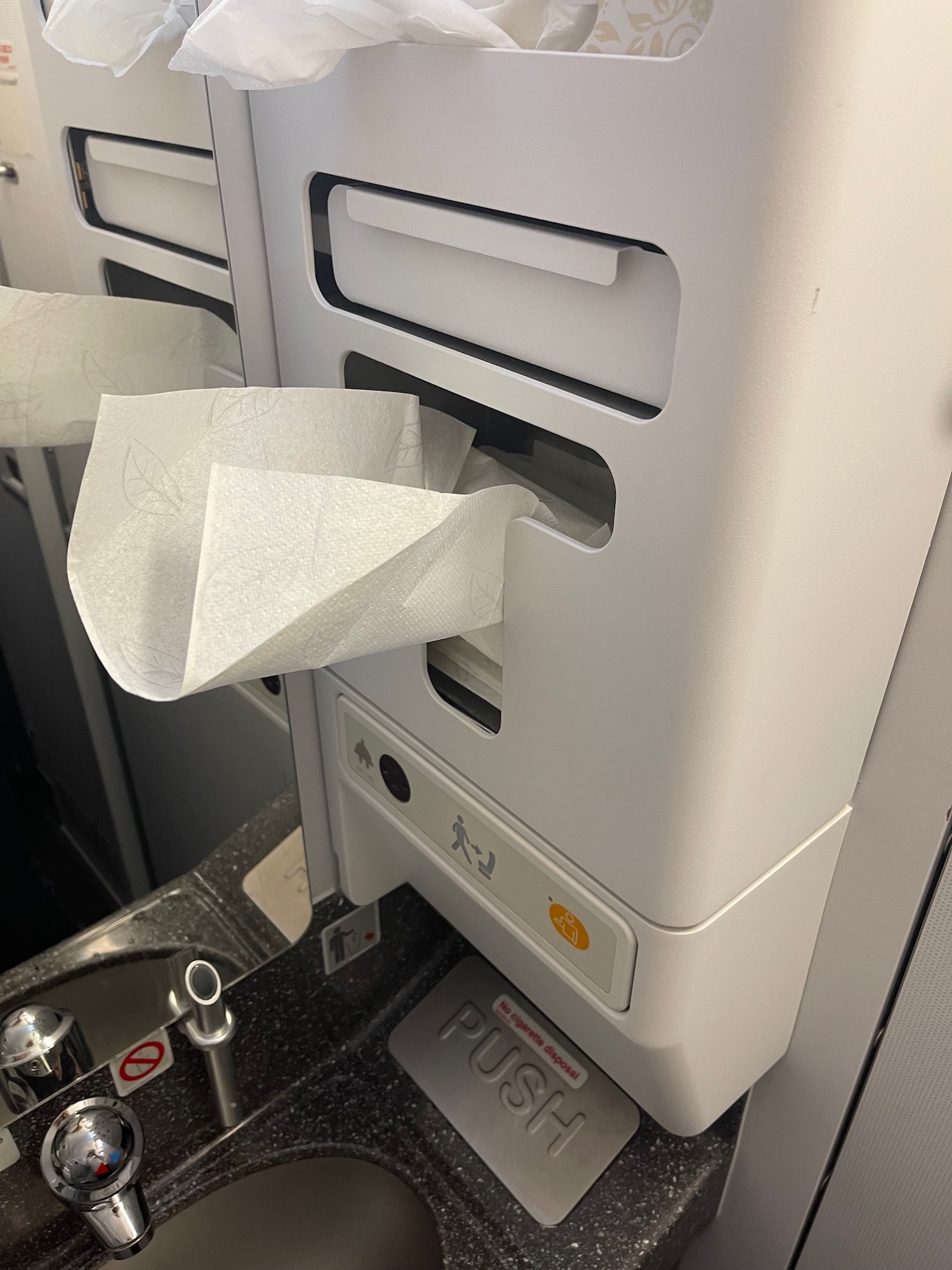 a tissue dispenser with a paper towel in it