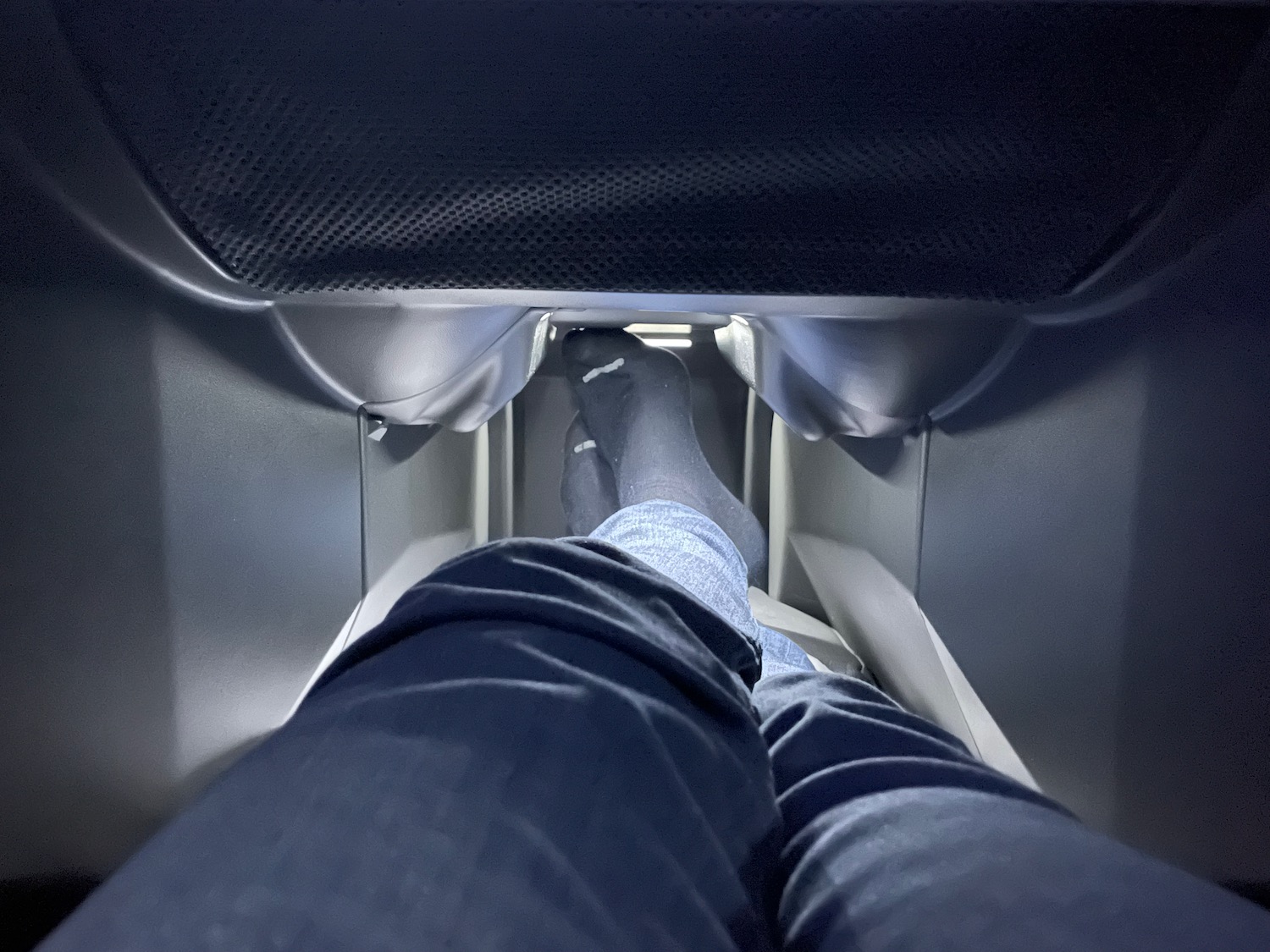 a person's feet in a plane