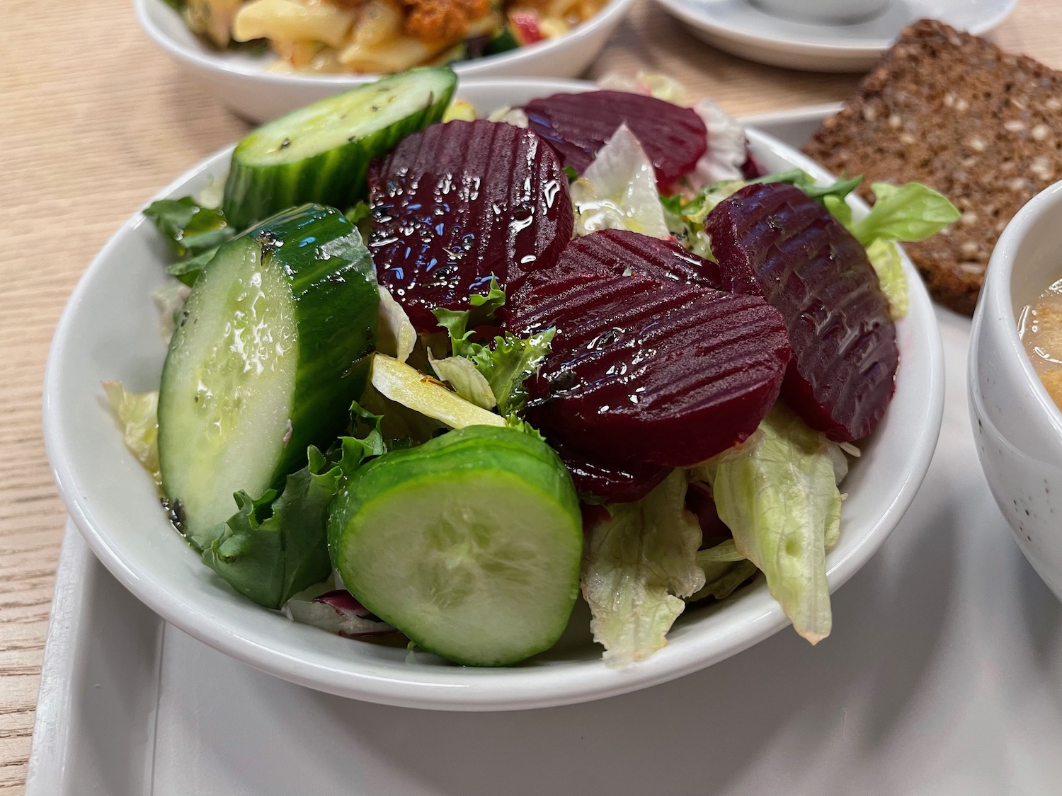 a bowl of salad with beets and cucumbers