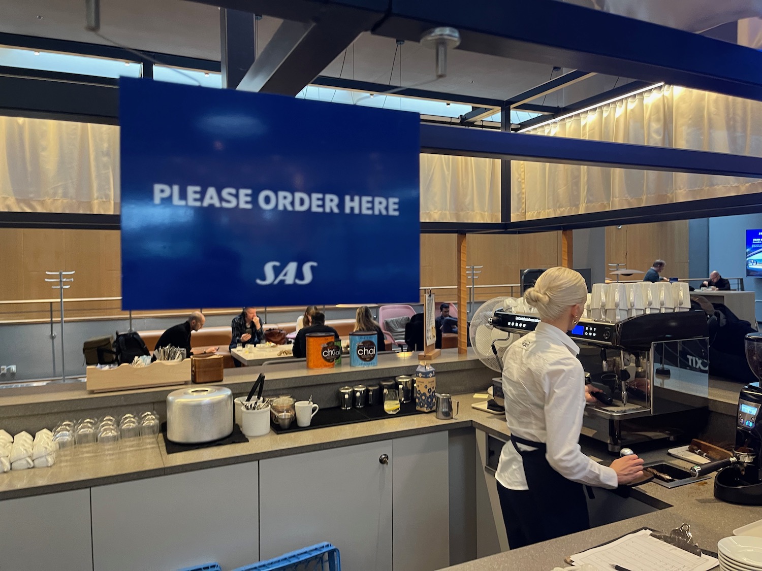 a woman standing behind a counter in a restaurant