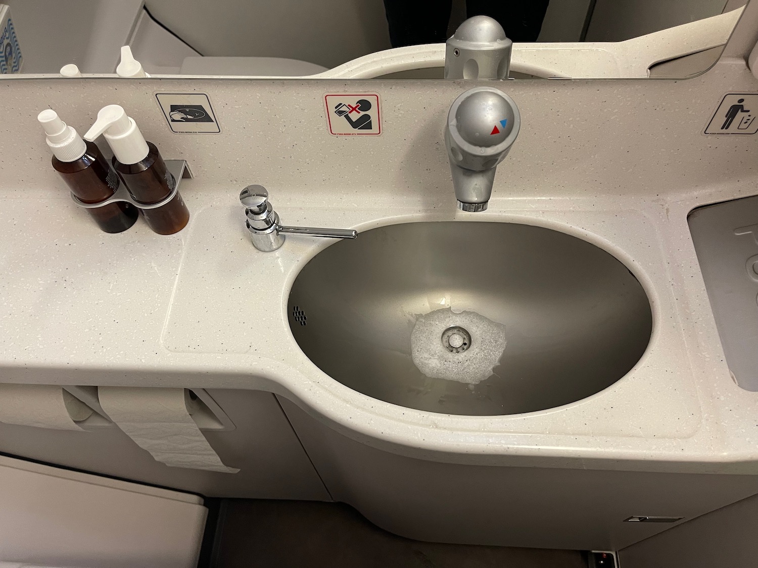 a sink with soap and soap bottles on the side