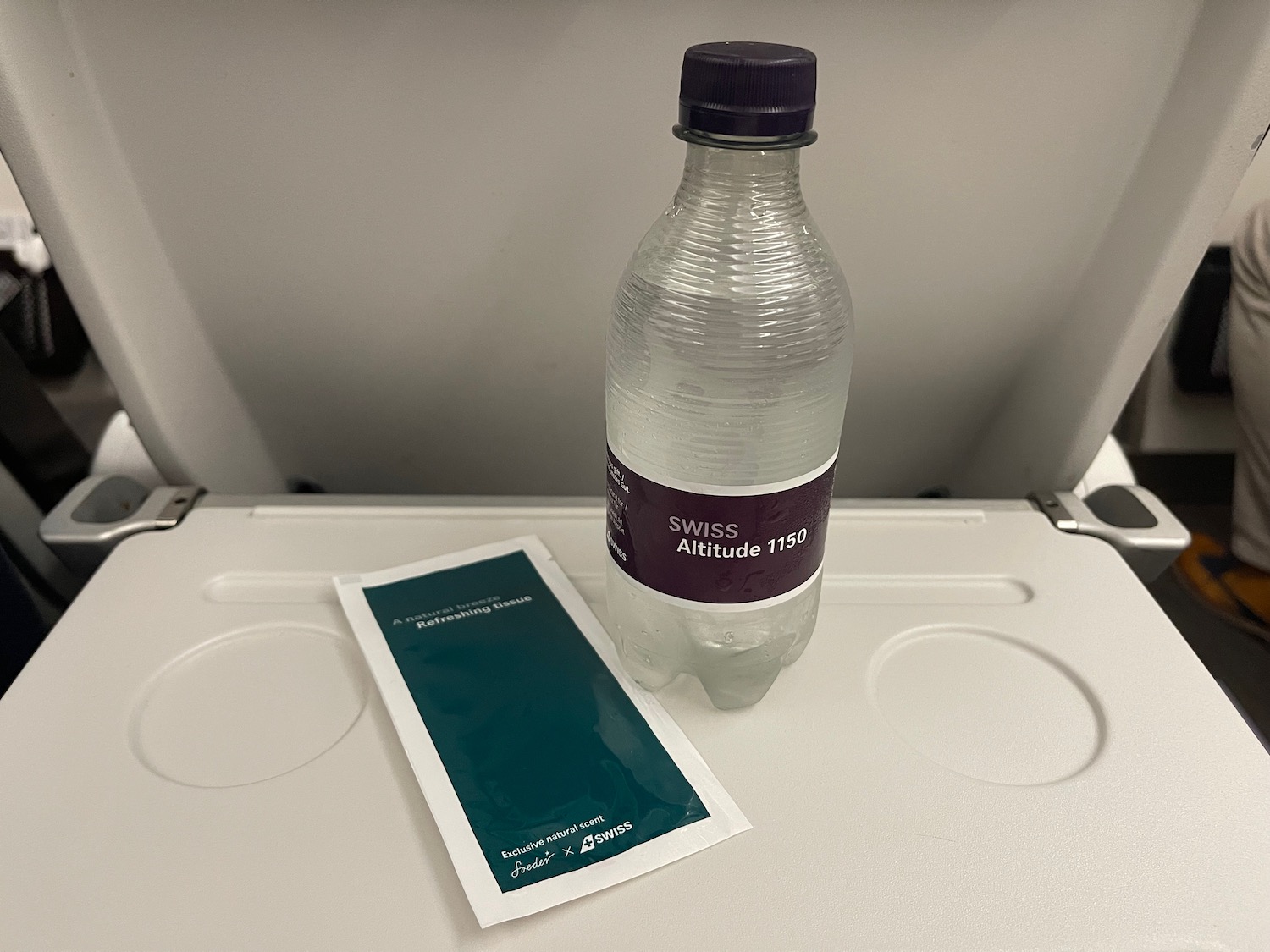 a bottle of water and a packet on a table