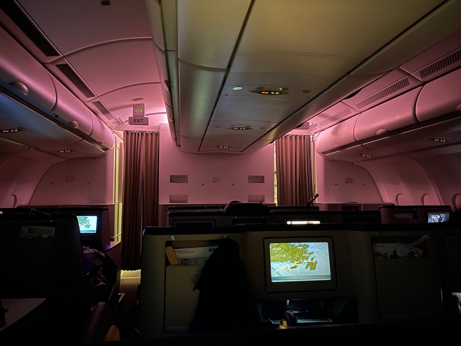 a pink room with a television and a window