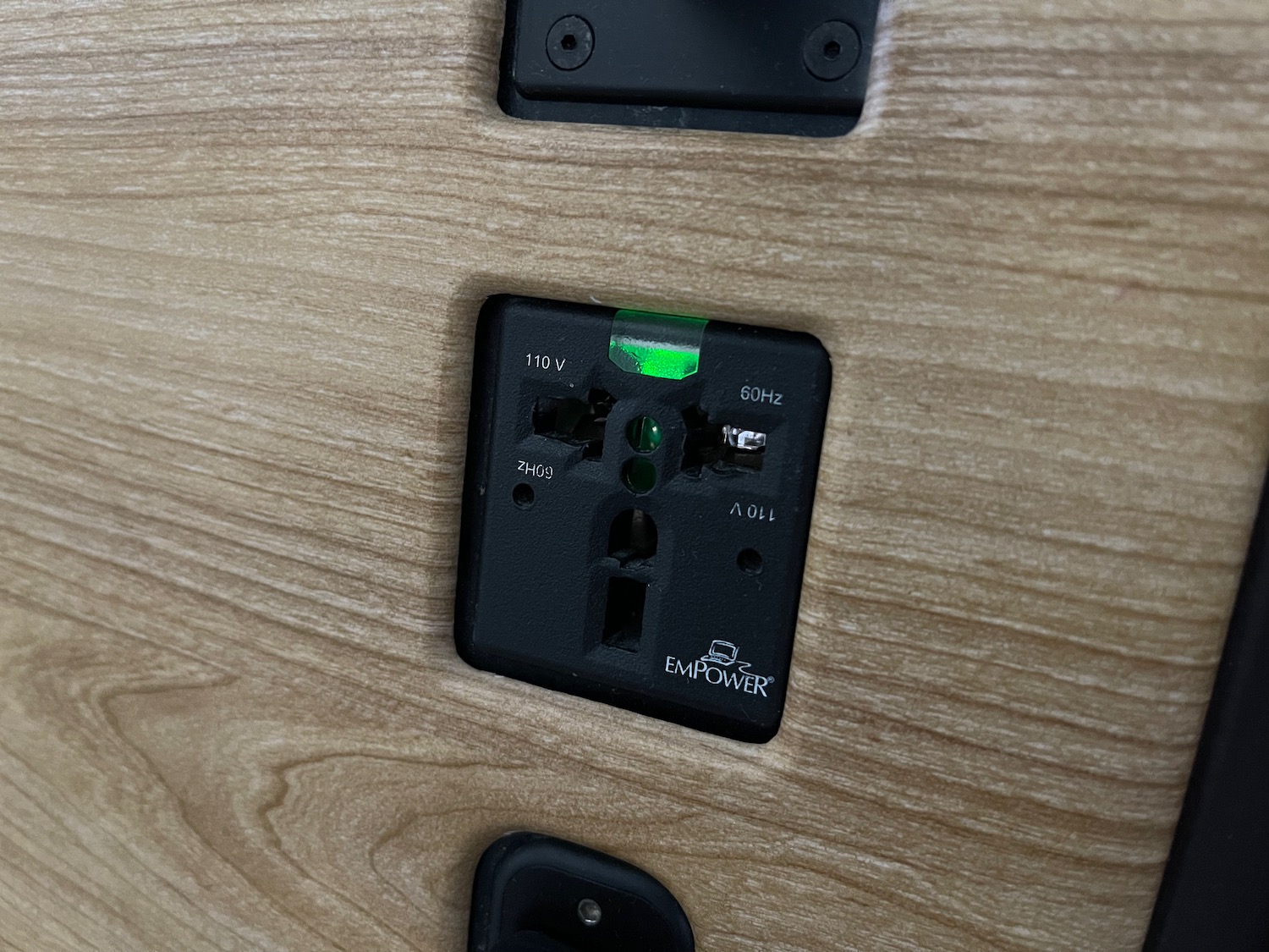 a black electrical outlet with green light