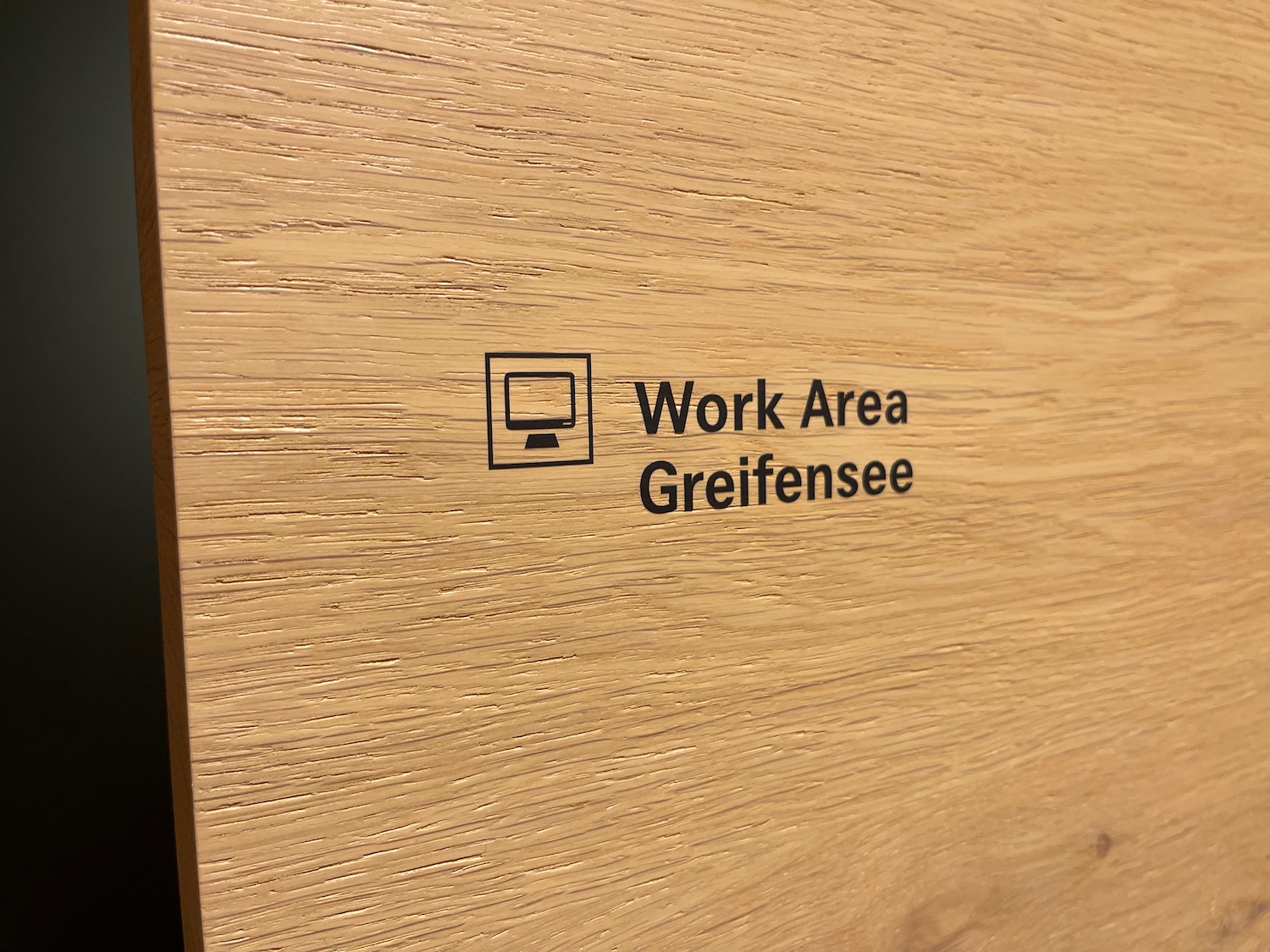 a wood surface with a black text and a computer on it