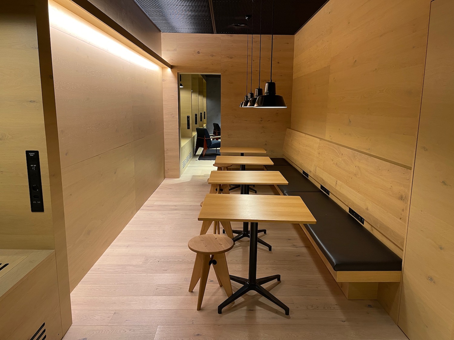 a long hallway with tables and benches