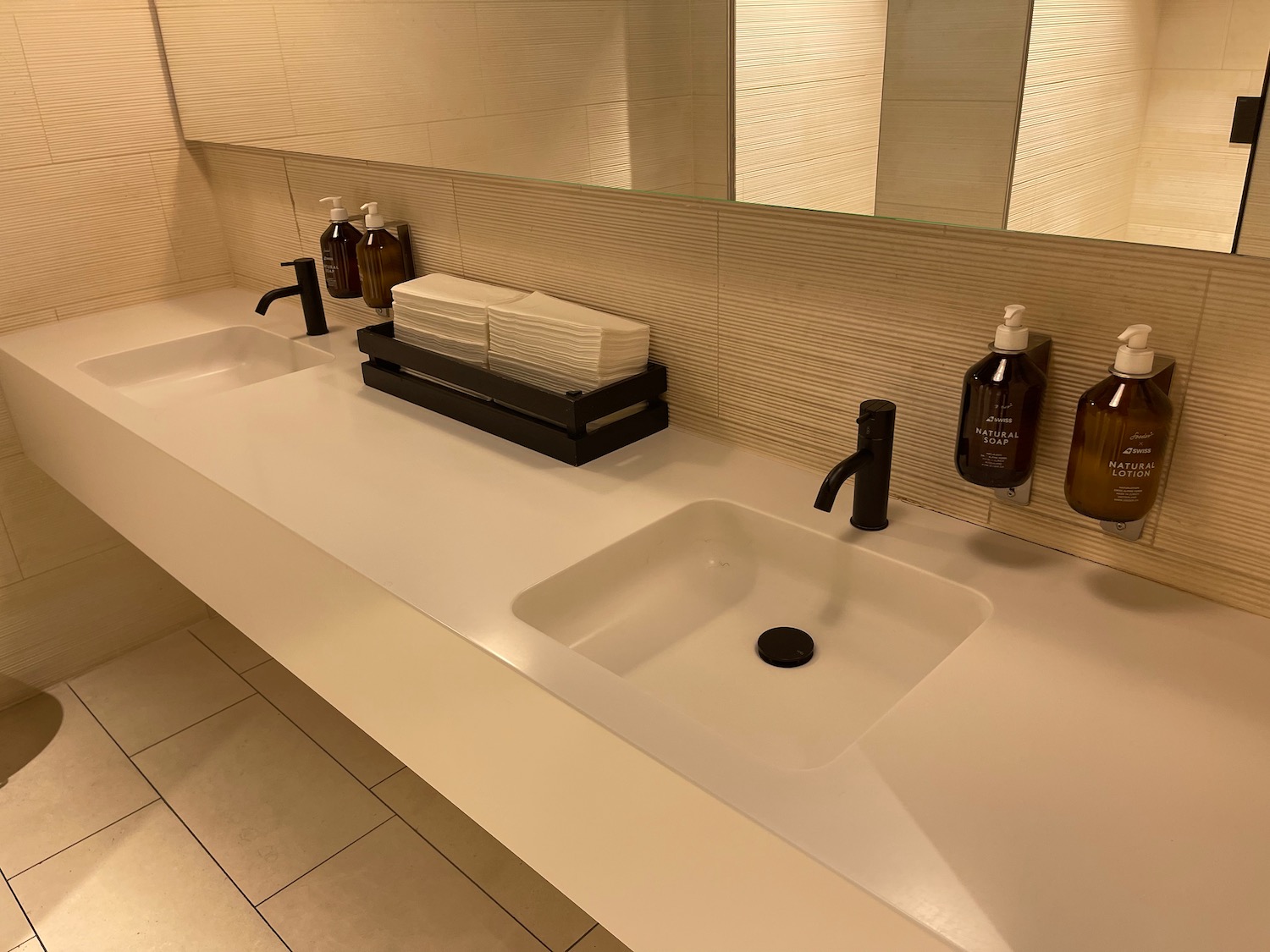 a bathroom sink with soap dispensers and soap bottles